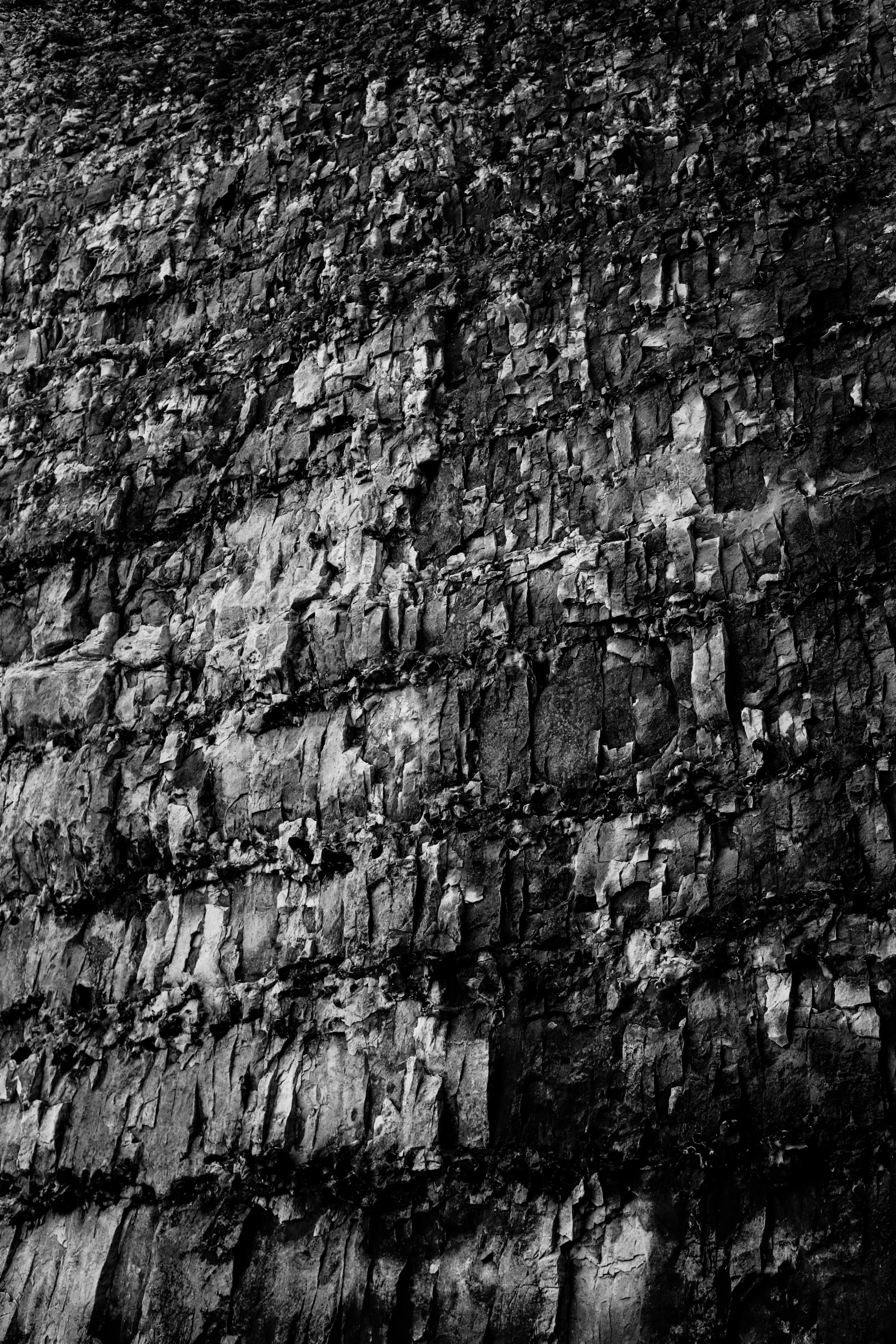 a black and white photo of a stone wall, an album cover, by Andrew Domachowski, geological strata, ffffound, felt!!! texture, wall wood fortress