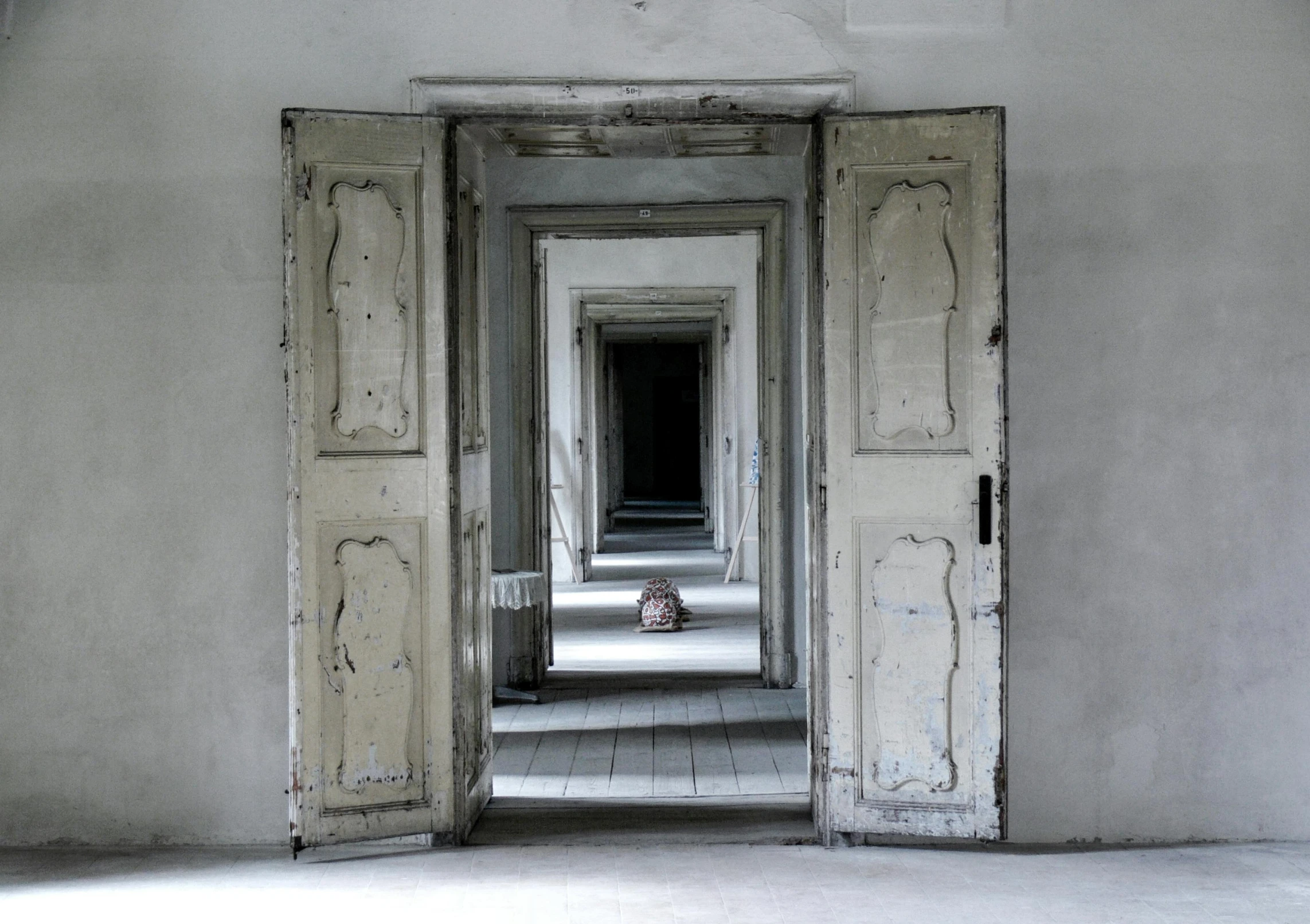 an open door leading to a hallway in a building, an album cover, inspired by Anna Füssli, pexels contest winner, surrealism, white floor, abandoned polish mansion, symmetrical portrait, biennale