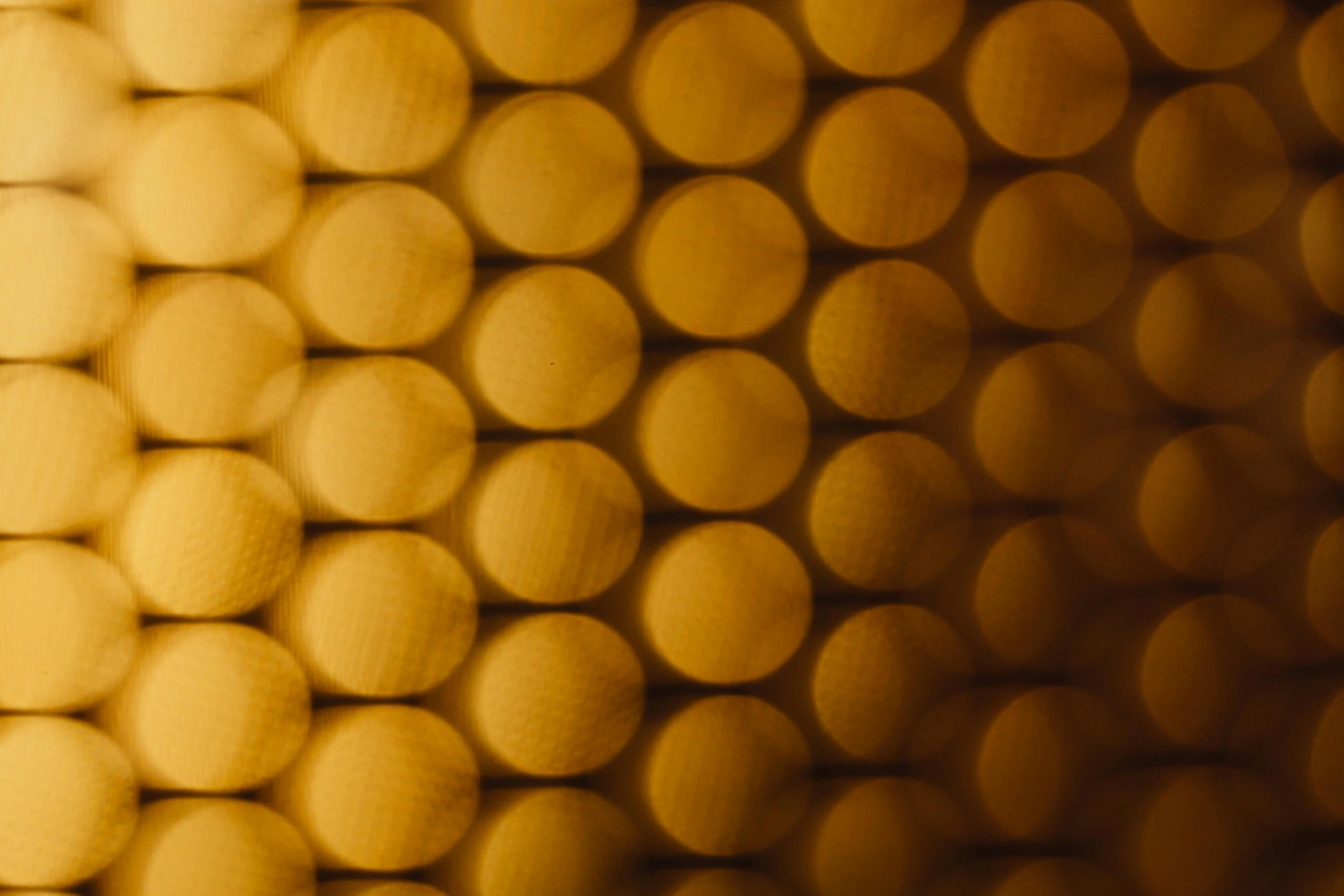 a close up of a wall made of circles, a microscopic photo, inspired by Andreas Gursky, unsplash, made of honey, soft light - n 9, tubes, 35mm 8k product photo