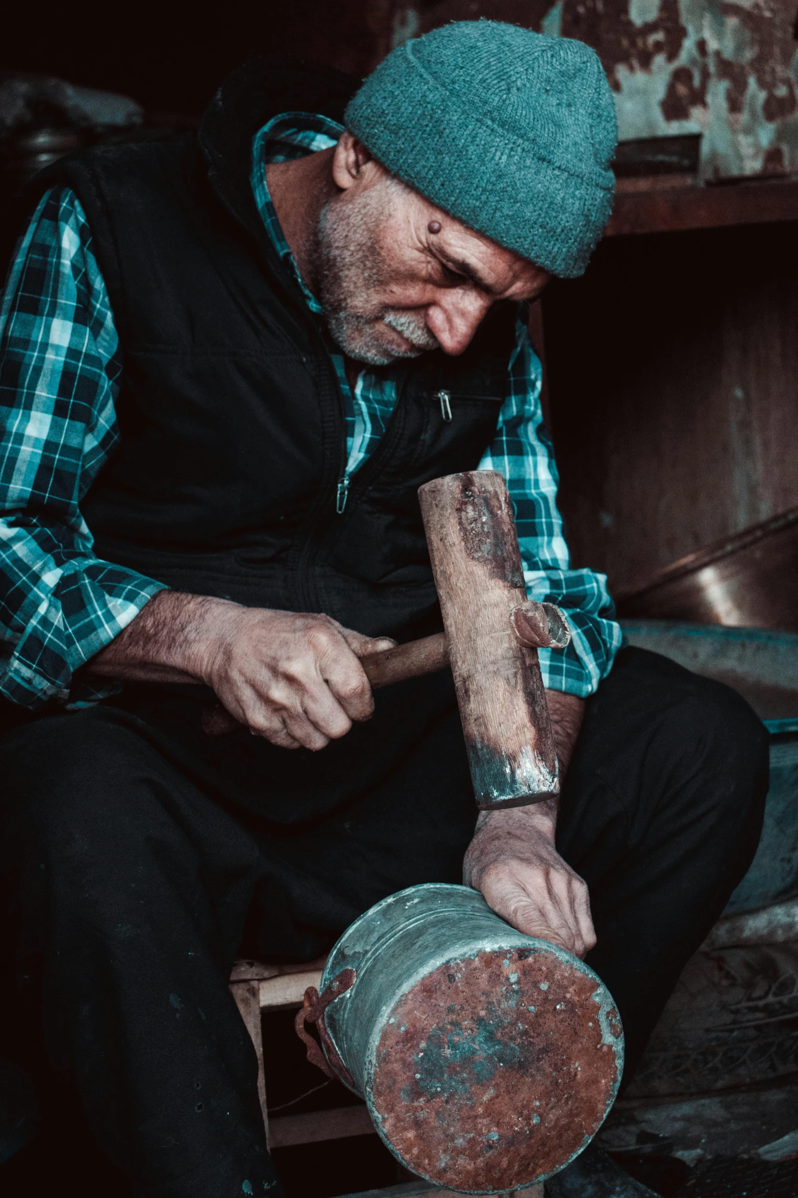 a man that is sitting down with a hammer, a portrait, pexels contest winner, mortar and pestle, australian, carving, older male