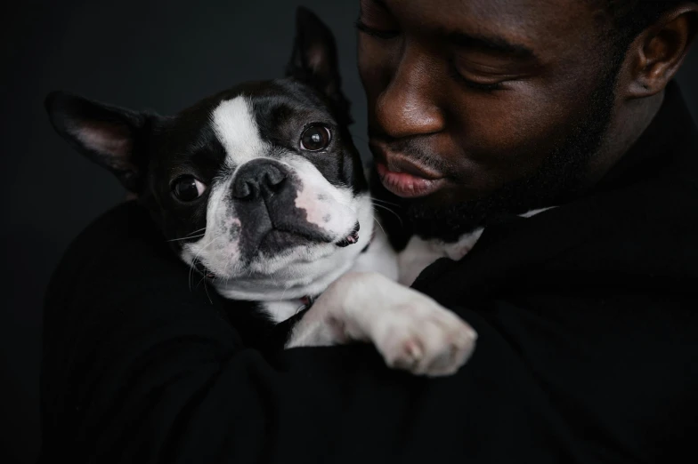 a man in a tuxedo holding a small dog, by Emma Andijewska, pexels contest winner, man is with black skin, french bulldog, hugging each other, [ cinematic