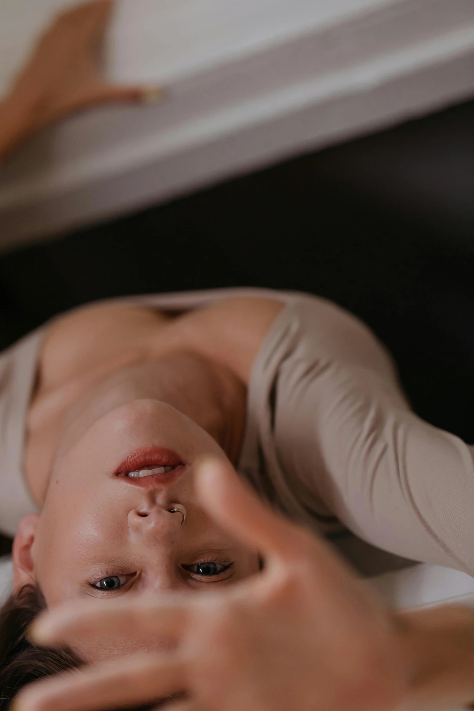 a close up of a person laying on a bed, a picture, inspired by Elsa Bleda, trending on pexels, renaissance, playful pose of a dancer, delicated facial features, low quality photo, contorted