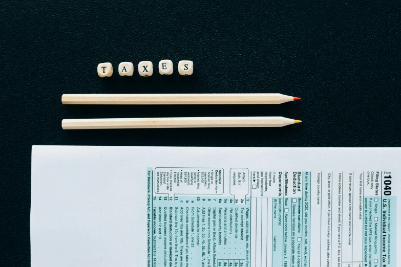 a pair of pencils sitting on top of a piece of paper, dices, listing image, rear facing, title