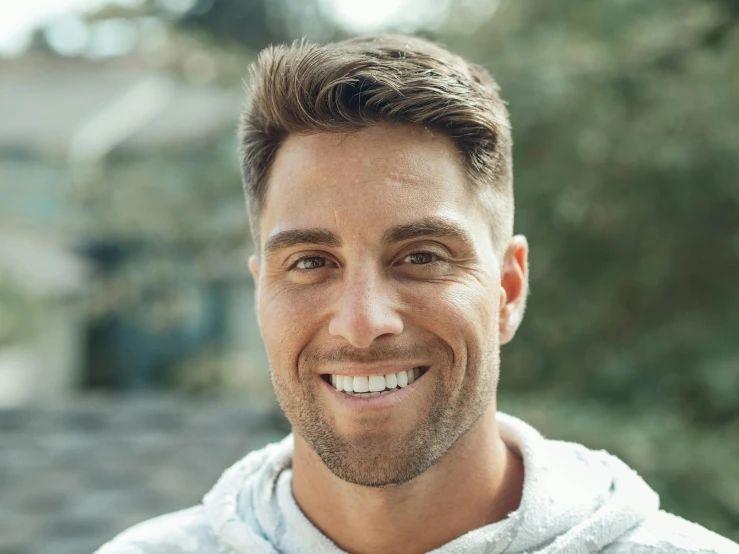 a close up of a person wearing a hoodie, smiling man, lean man with light tan skin, ash thorp, dentist