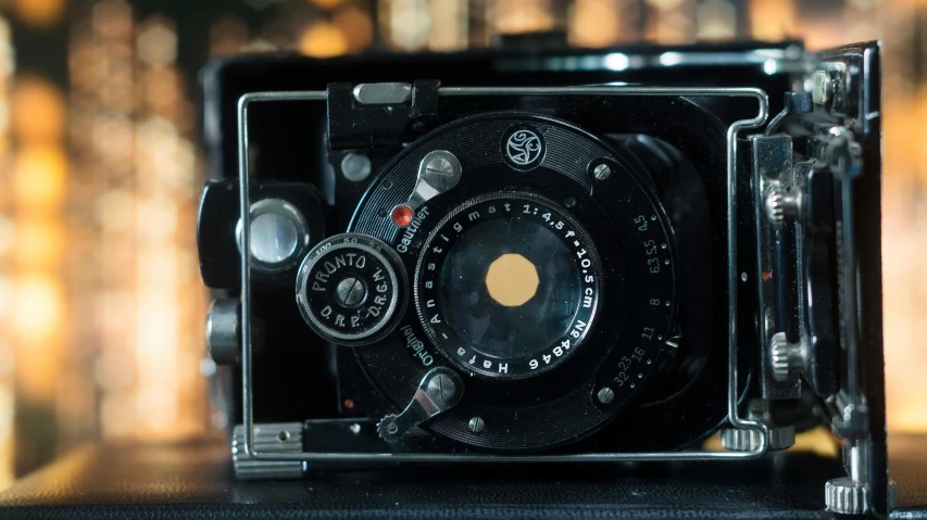 a black camera sitting on top of a table, a picture, by Sven Erixson, unsplash, vintage footage, medium format, hyperdetailed photograph, shot of a highly detailed