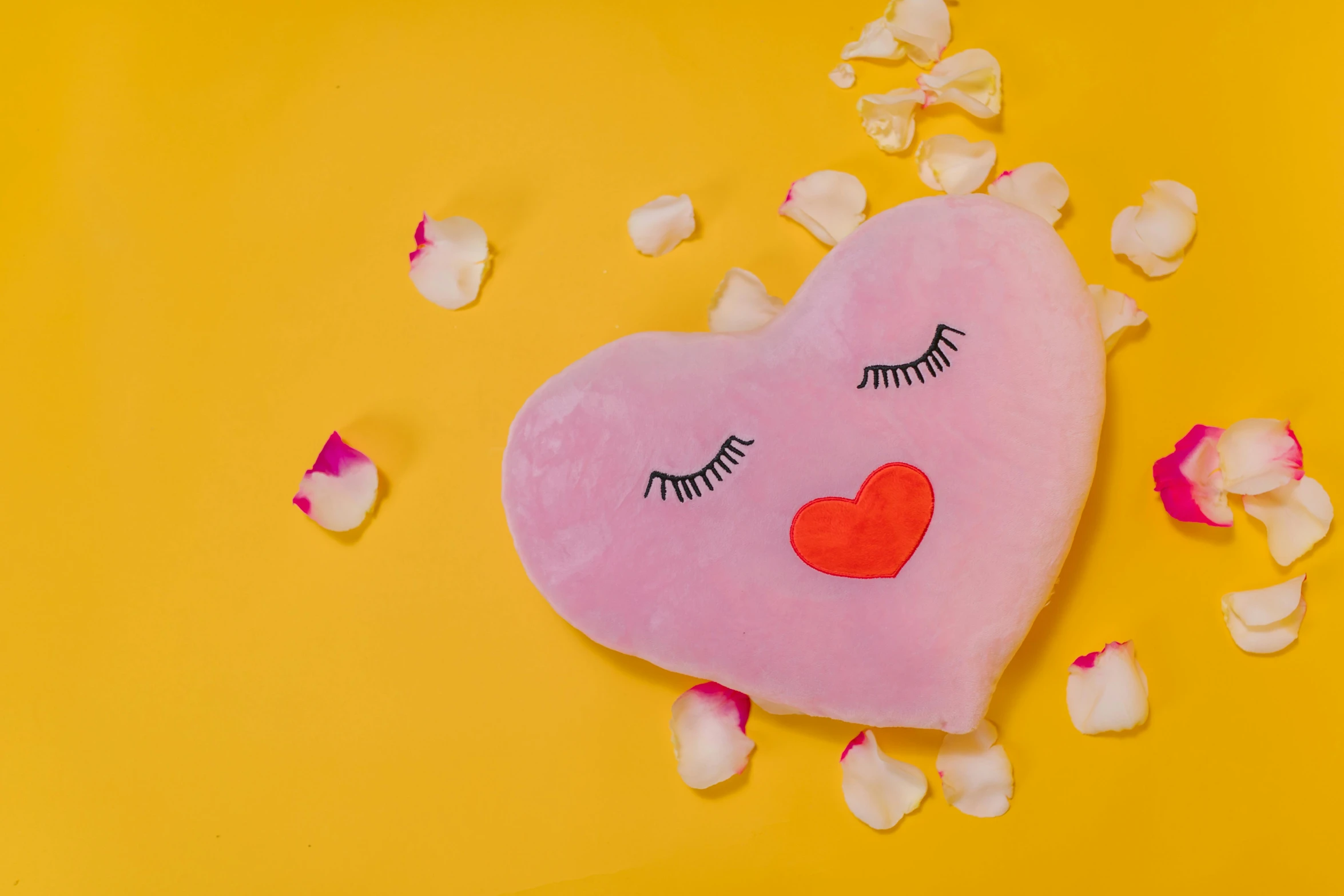 a pink heart with closed eyes surrounded by petals, by Julia Pishtar, cushions, product shot, on a yellow canva, plush lips