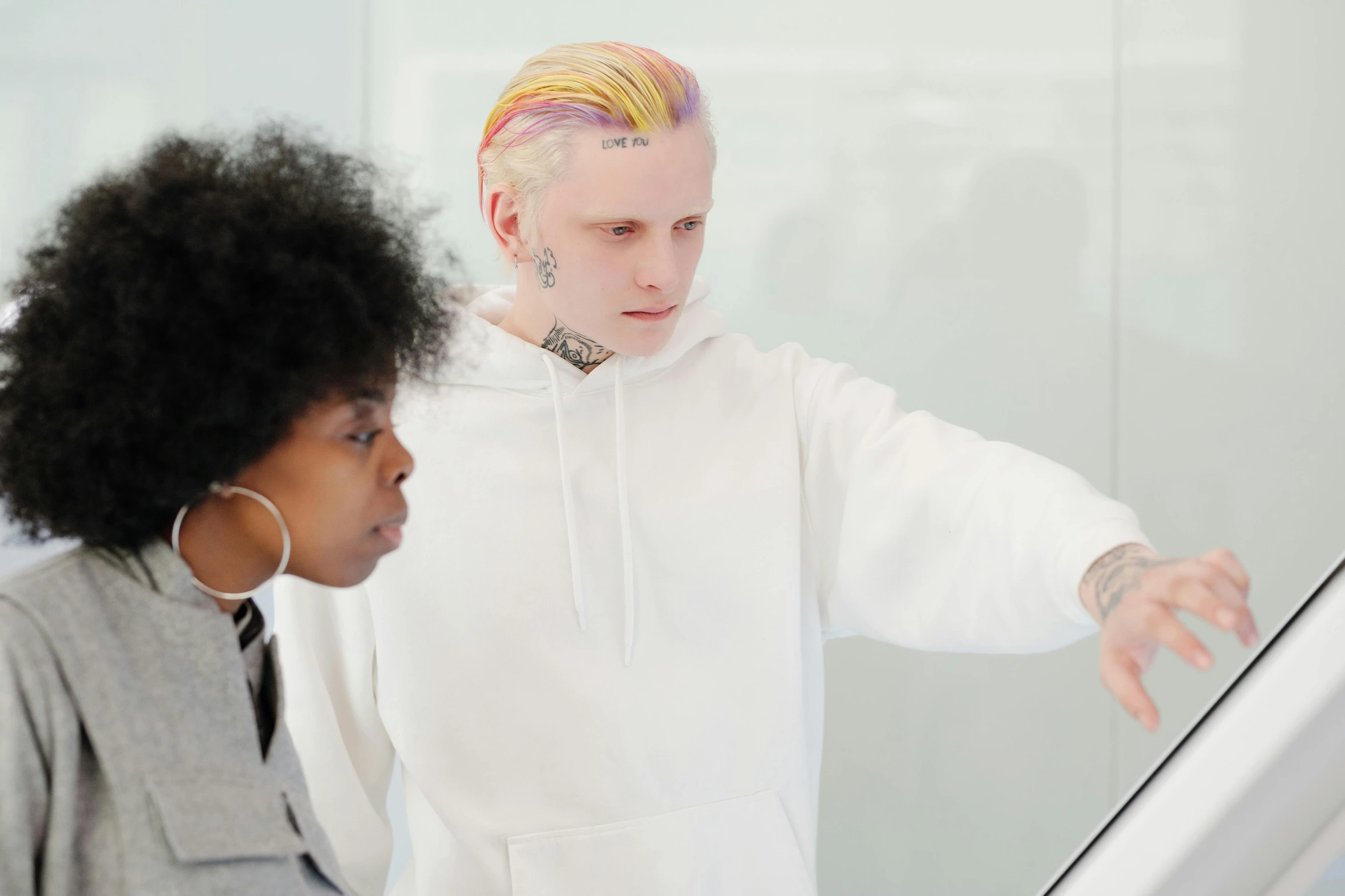 a man and a woman looking at a computer screen, trending on pexels, visual art, albino hair, standing in class, undercut hairstyle, young thug