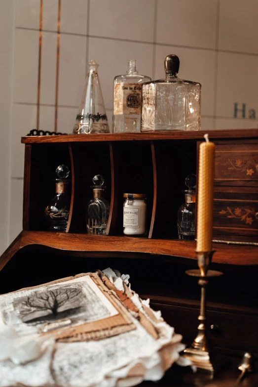 a book sitting on top of a wooden desk, alchemist bottles, haunted house themed, profile image, cabinet furniture