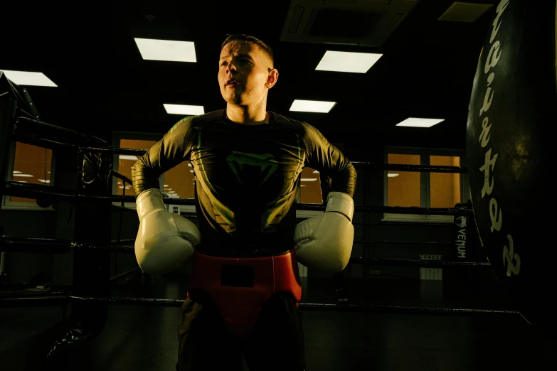 a man standing in the middle of a boxing ring, profile image, superhero, liam brazier, combat suit