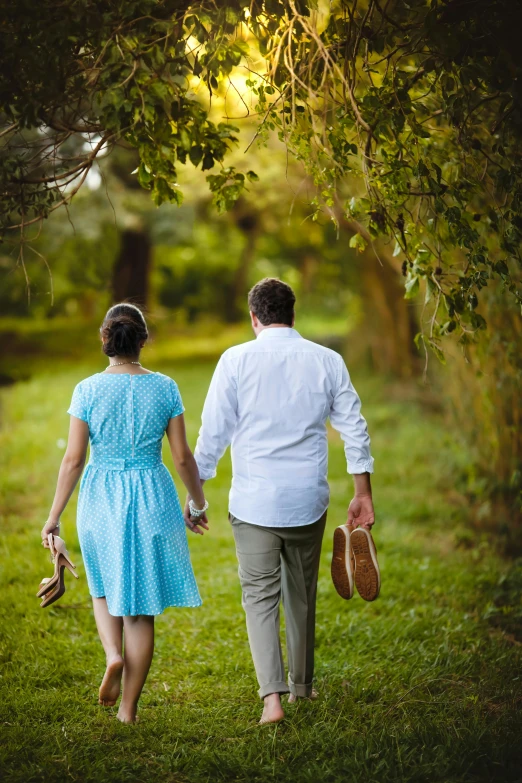 a man and woman walking down a path holding hands, lush surroundings, in a open green field, quaint, planning