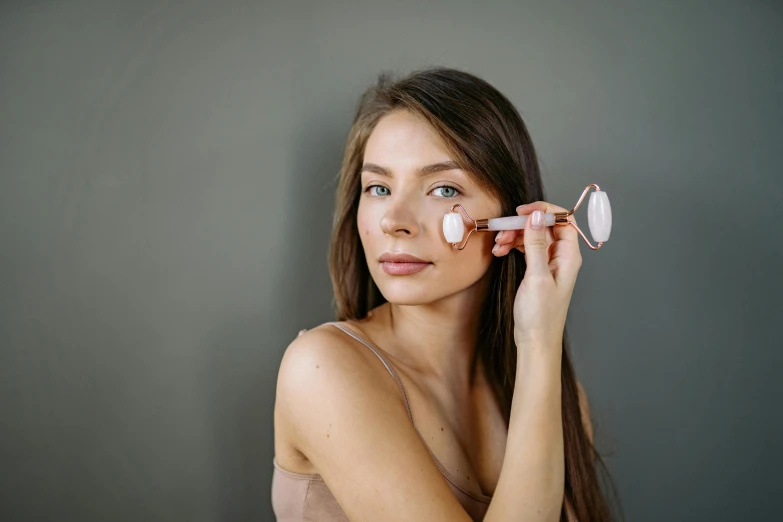 a woman brushes her teeth with a toothbrush, a portrait, by Julia Pishtar, trending on pexels, rose gold, porcelain highlighted skin, woman is curved, foam