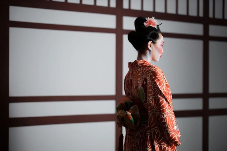 a woman in a kimono standing in front of a wall, inspired by Uemura Shōen, unsplash, japan. volumetric lighting, nezuko-chan, concert, ethnicity : japanese