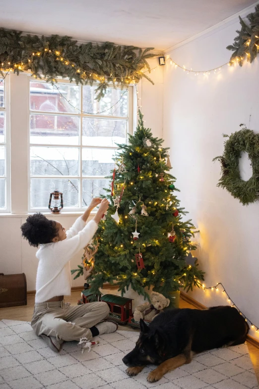 a woman decorating a christmas tree in a living room, by Julia Pishtar, natural lights, vine, flat, cut