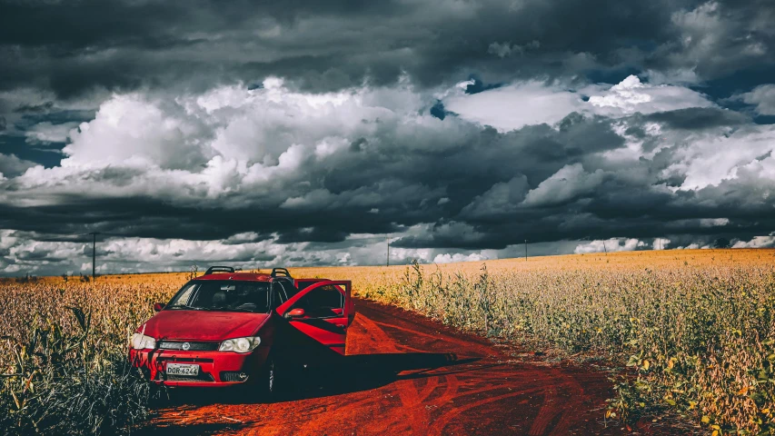 a red truck driving down a dirt road, an album cover, by Adam Marczyński, romanticism, turbulent storm clouds, lada car, unsplash 4k, 000 — википедия