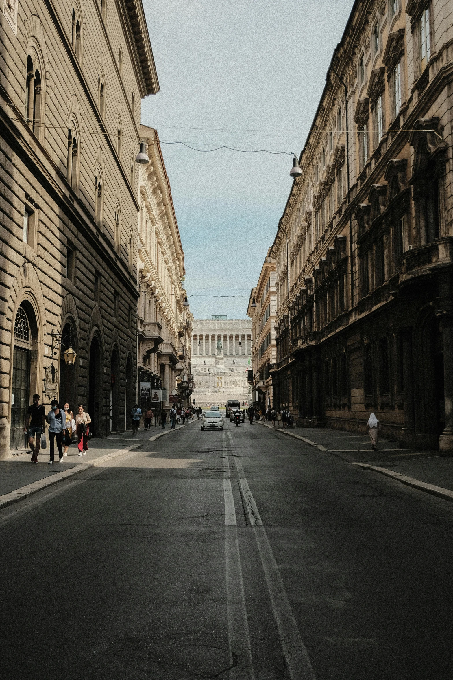 a narrow city street lined with tall buildings, by Alessandro Allori, pexels contest winner, neoclassicism, royal palace, gif, distant photo, square