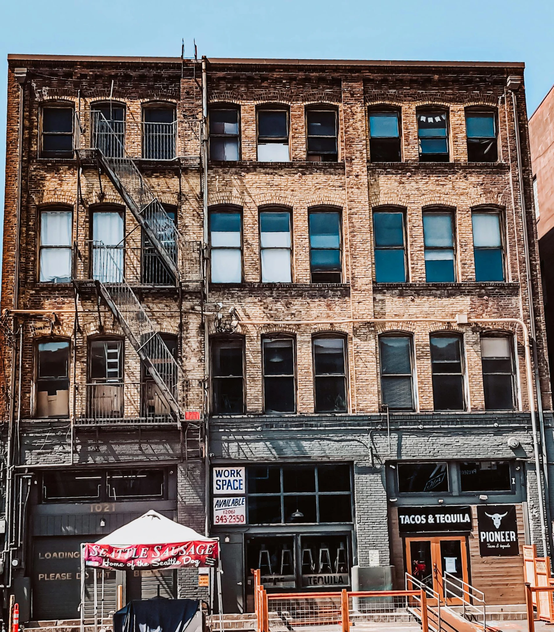 a red fire hydrant sitting in front of a tall building, by Meredith Dillman, pexels contest winner, a cozy old victorian loft, scaffolding collapsing, storefronts, gif