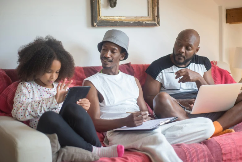 a couple of people sitting on a couch with a laptop, families playing, malcolm hart, promo image, advanced economy