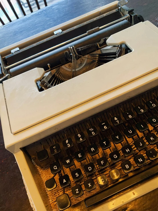 an old typewriter sitting on top of a table, thumbnail, profile image, iphone photo, full body close-up shot