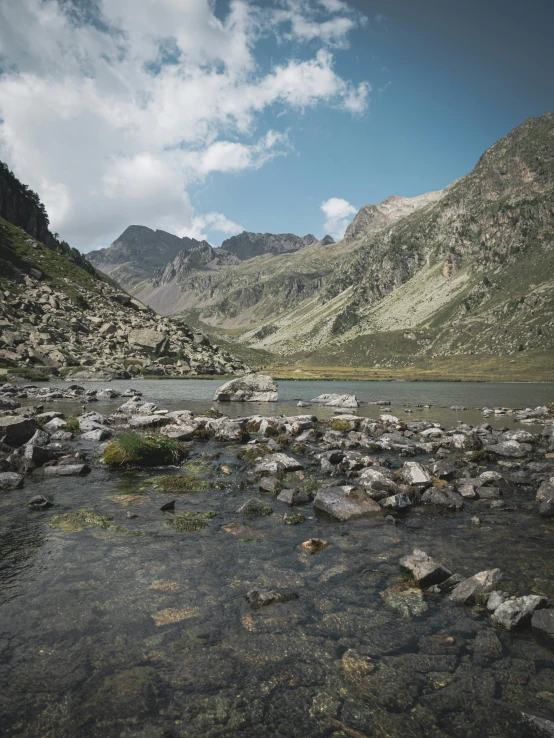 a body of water surrounded by rocks and mountains, atlach - nacha, high quality image”