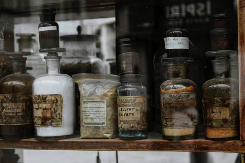 a bunch of bottles that are on a shelf, pexels contest winner, renaissance, storefront, dressed in an old white coat, jars, brown