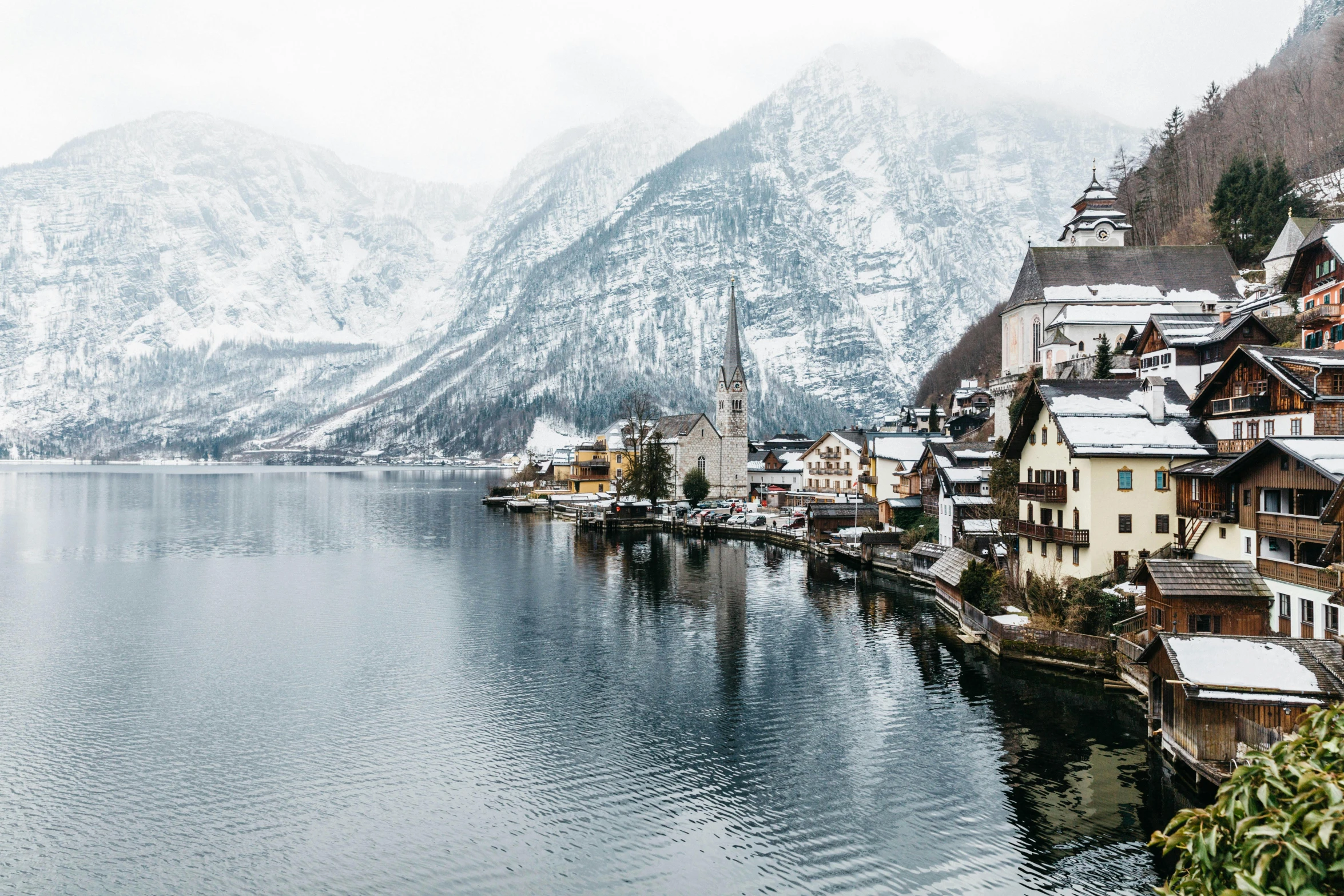 a large body of water surrounded by snow covered mountains, by Sebastian Spreng, pexels contest winner, quaint village, grey, fine art print, multiple stories