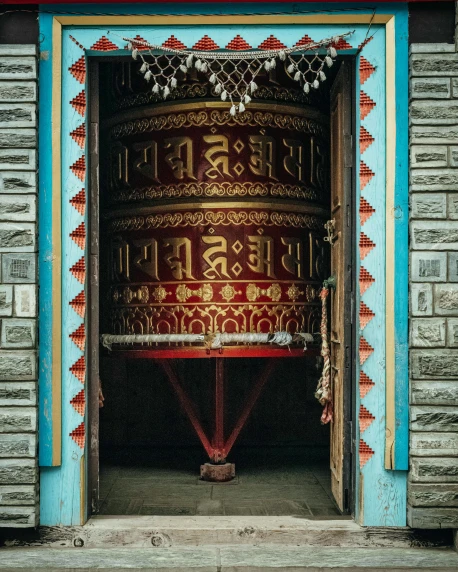 a large bell hanging from the side of a building, an album cover, pexels contest winner, cloisonnism, omar shanti himalaya tibet, symmetrical doorway, thumbnail, barrels