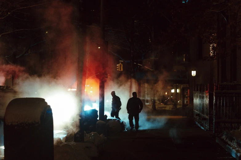 a group of people standing next to a fire hydrant, a photo, inspired by Elsa Bleda, pexels contest winner, city sunset mist neon lights, moroccan new york city street, cold blue light, :6 smoke grenades