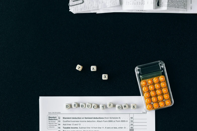 a calculator sitting on top of a table next to a calculator, by Adam Rex, trending on pexels, dices map book miniatures, bubble letters, flat lay, 1970s photo