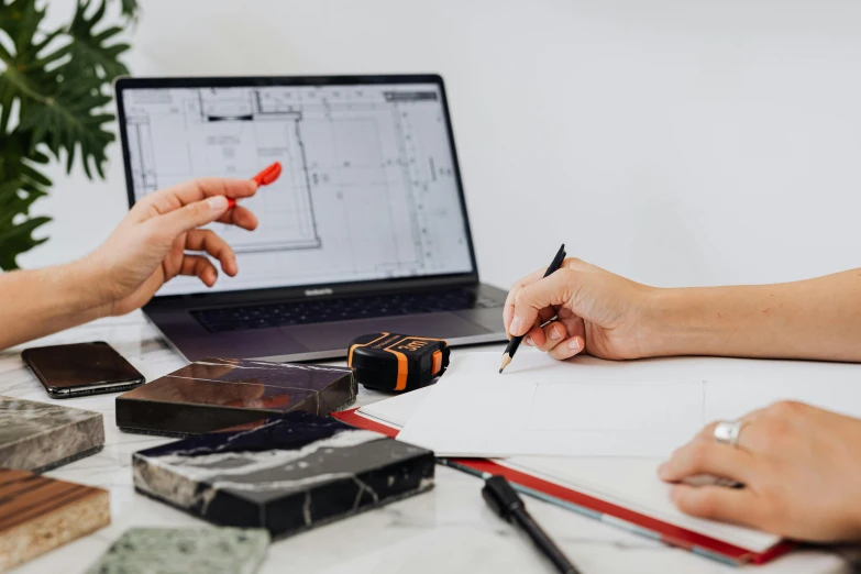 a couple of people sitting at a table with a laptop, a detailed drawing, pexels contest winner, architectural scale, holding pencil, classic product design, ¯_(ツ)_/¯