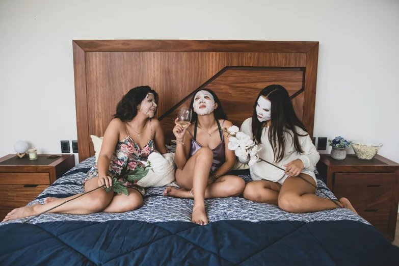 a group of women sitting on top of a bed, pexels contest winner, aestheticism, smiling mask, white face paint, trio, shunga style