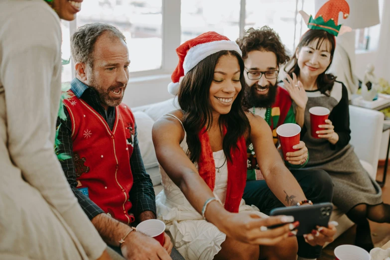 a group of people sitting next to each other on a couch, a photo, pexels contest winner, happening, wearing festive clothing, she is holding a smartphone, pictured from the shoulders up, avatar image