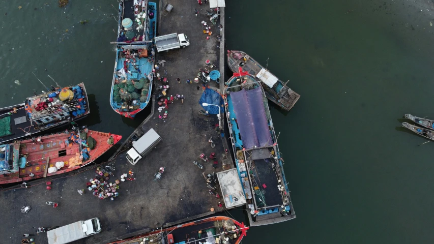 a group of boats sitting on top of a body of water, by Daniel Lieske, pexels contest winner, fish market, satellite imagery, thumbnail, zezhou chen