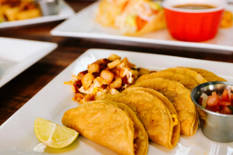 a close up of a plate of food on a table, by Carey Morris, pexels, tacos, puerto rico, square, dumplings on a plate