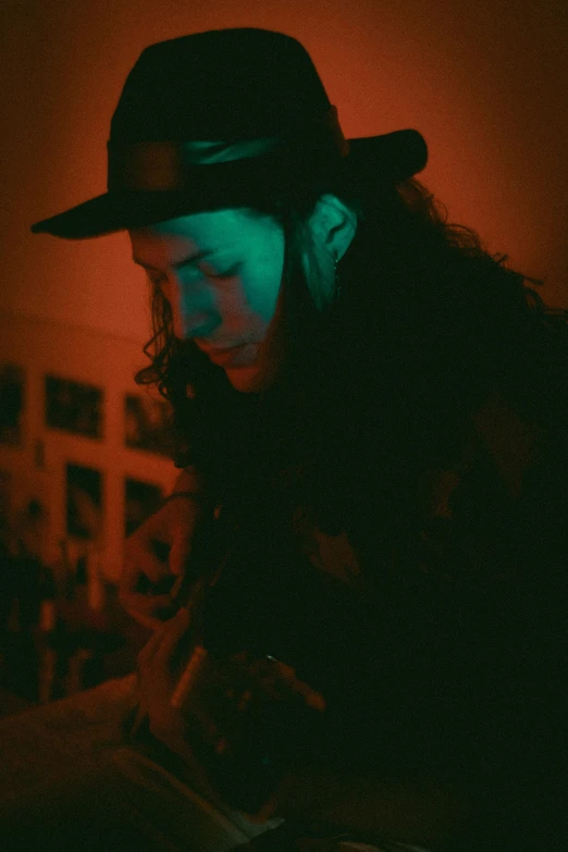 a man in a hat playing a guitar, an album cover, by Emily Mason, reddit, private press, portrait soft low light, psychedelic photoluminescent, woman, live performance