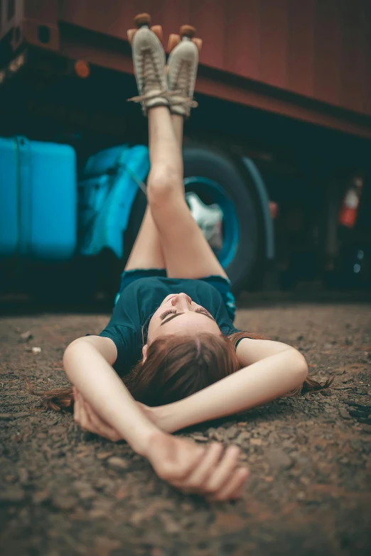 a woman laying on the ground in front of a truck, pexels contest winner, girl graceful, mechanic, 15081959 21121991 01012000 4k, head tilted downward