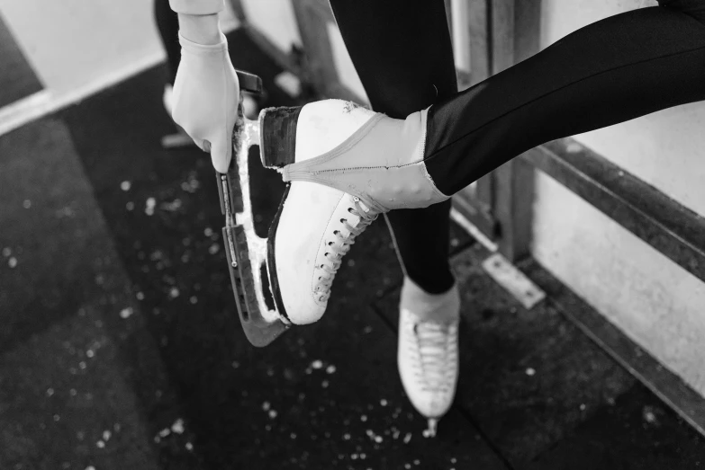 a black and white photo of a pair of shoes, a black and white photo, by Emma Andijewska, pexels contest winner, wearing skating helmet, wearing white tights, ice princess, unknown artist