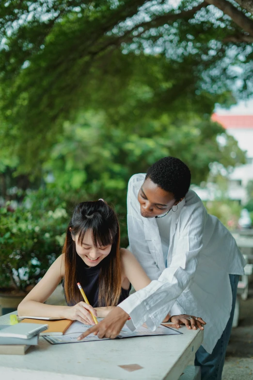 a couple of people that are sitting at a table, a picture, by Reuben Tam, academic art, writing a letter, in garden, college students, ao dai