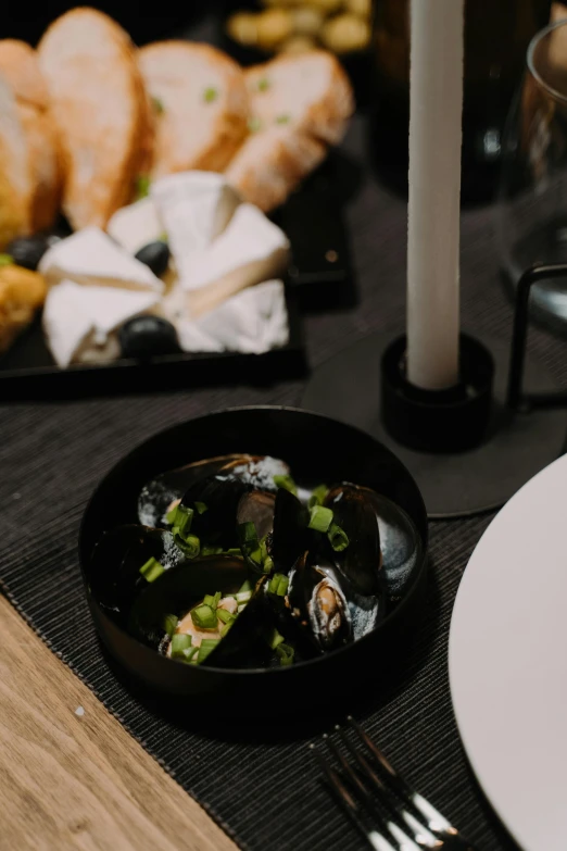 a close up of a plate of food on a table, by Jan Tengnagel, unsplash, modernism, deep black, bowl filled with food, abalone, 15081959 21121991 01012000 4k