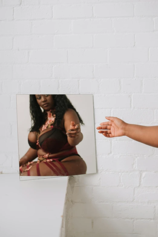 a woman that is standing in front of a mirror, an album cover, by Lily Delissa Joseph, trending on pexels, visual art, belly button showing, 144x144 canvas, plus size, hand gesture