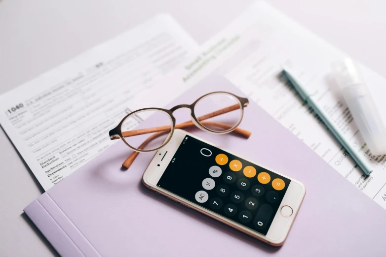 a cell phone sitting on top of a book next to a pair of glasses, trending on pexels, hurufiyya, maths, rich colour, thumbnail