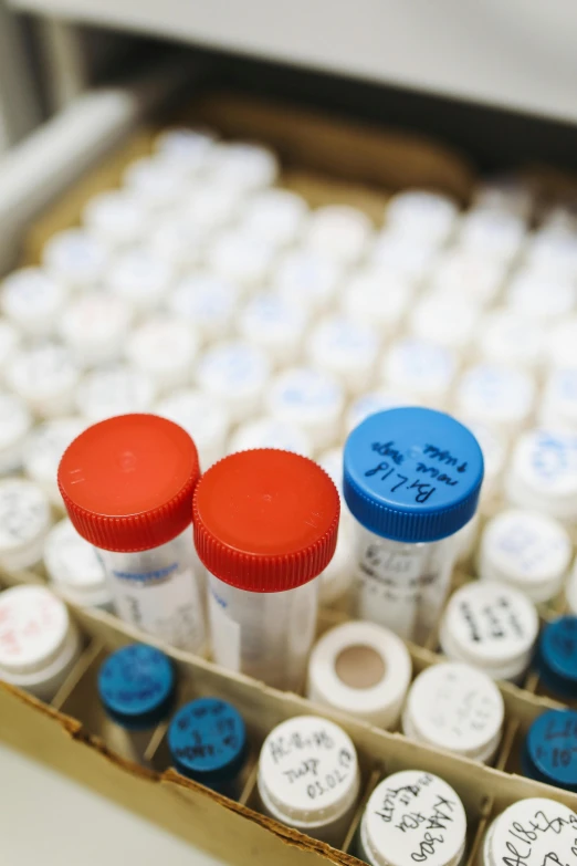 a box filled with lots of different colored vials, stood in a lab, thumbnail, medical labels, dials