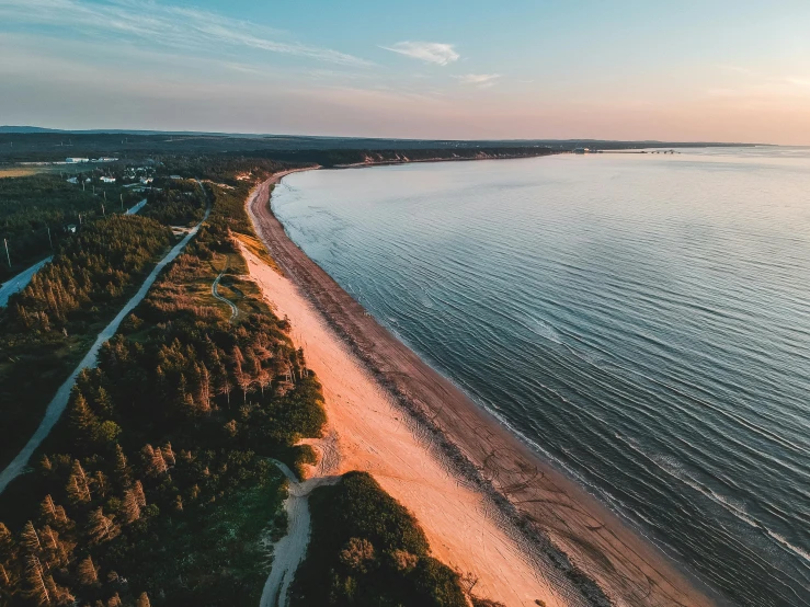 an aerial view of a beach at sunset, by Adam Marczyński, pexels contest winner, quebec, long view, thumbnail, high quality image