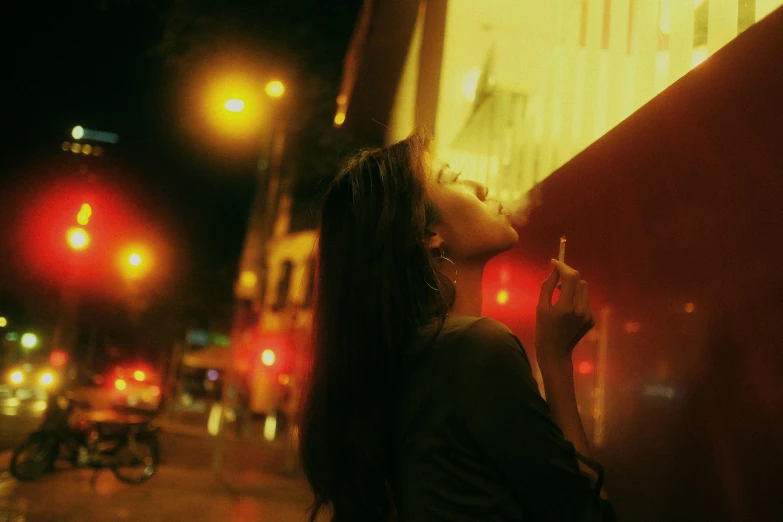 a woman smoking a cigarette on a city street at night, a picture, keng lye, **cinematic, flirting, photoillustration