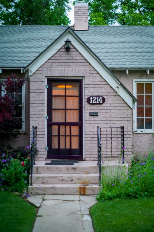 a house with a number on the front door, a colorized photo, by Sven Erixson, magic hour photography, colorado, airbnb, subtle purple accents