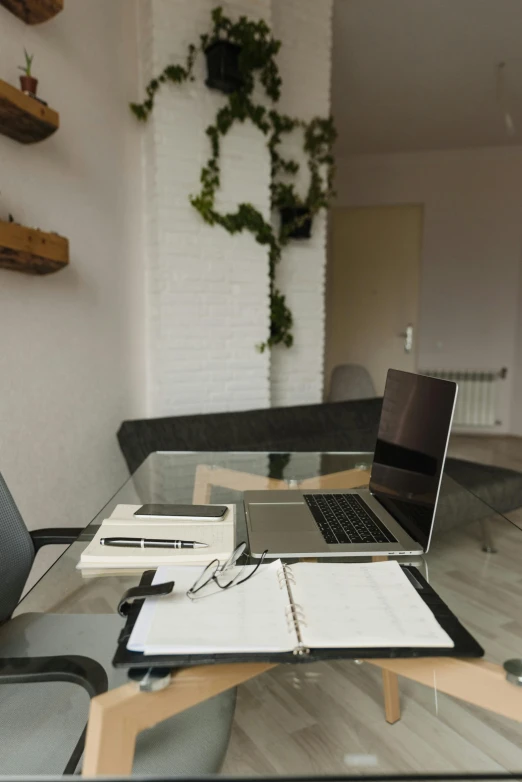 a laptop computer sitting on top of a glass table, papers on table, high-quality photo, decorations, trending photo