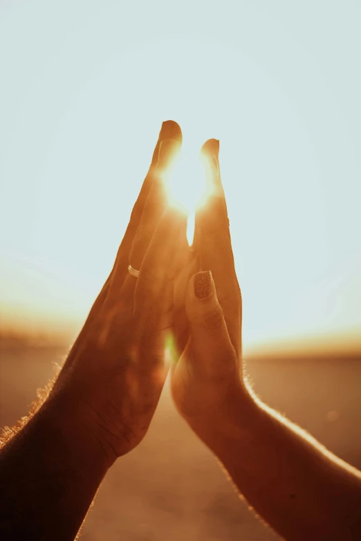 a person holding their hands in front of the sun, prayer hands, instagram post, paul barson, commercially ready