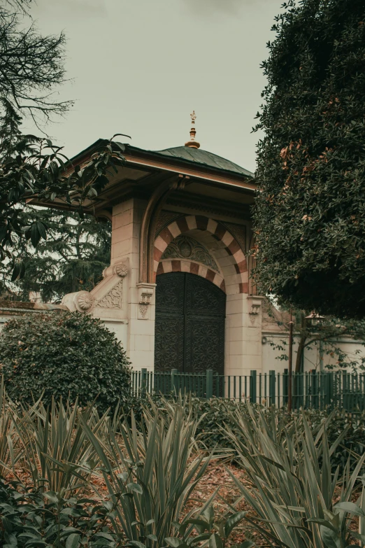 a gazebo sitting on top of a lush green field, unsplash, art nouveau, istanbul, large gate, 1990s photograph, contain