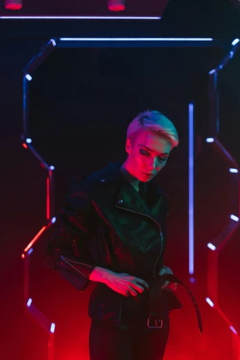 a man standing in front of a red light, an album cover, inspired by Yanjun Cheng, futurism, short platinum hair tomboy, dark backdrop, cinematic outfit photo, anton fadeev 8 k
