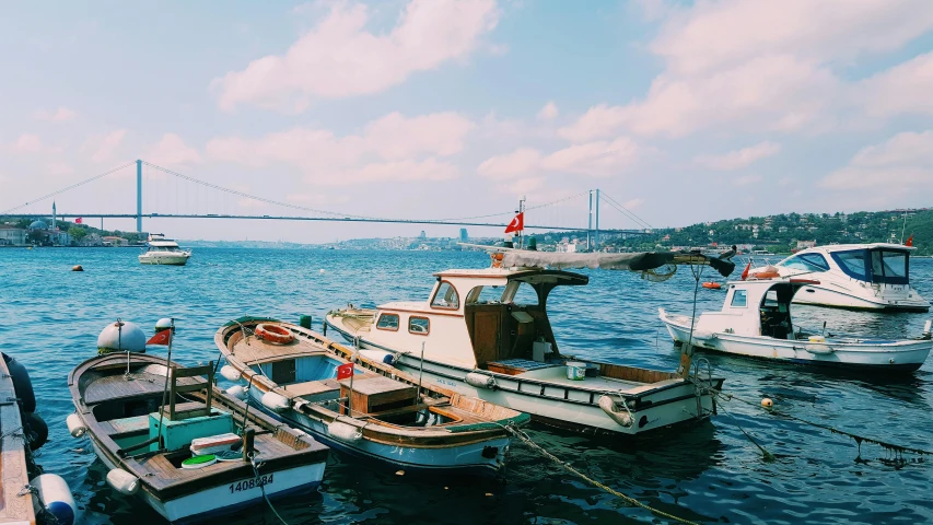 a number of boats in a body of water, a colorized photo, pexels contest winner, hurufiyya, 🤠 using a 🖥, istanbul, small dock, clear and sunny