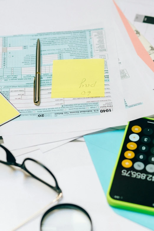 a green calculator sitting on top of a table, paper cutouts of plain colors, yellow and black color scheme, promo image, stacks